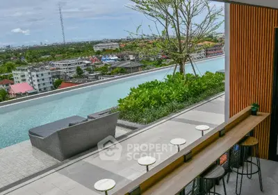 Stunning rooftop pool with panoramic city views and modern seating area.