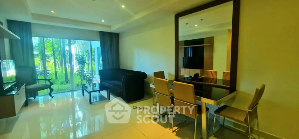 Spacious living room with modern furniture and large window view of lush greenery.