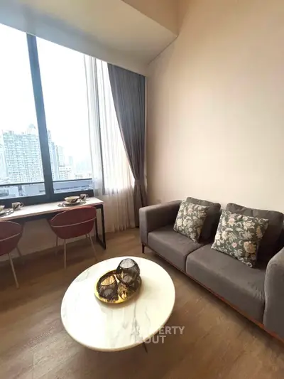 Modern living room with city view, stylish furniture, and elegant decor in a high-rise apartment.