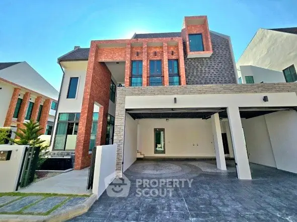 Stunning modern house exterior with spacious driveway and unique architectural design.