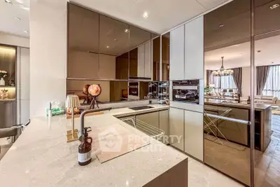 Luxurious modern kitchen with sleek cabinetry and open layout in a stylish apartment.