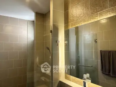 Modern bathroom with glass shower and elegant tile design