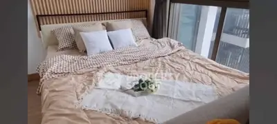 Luxurious bedroom with large windows offering stunning city views
