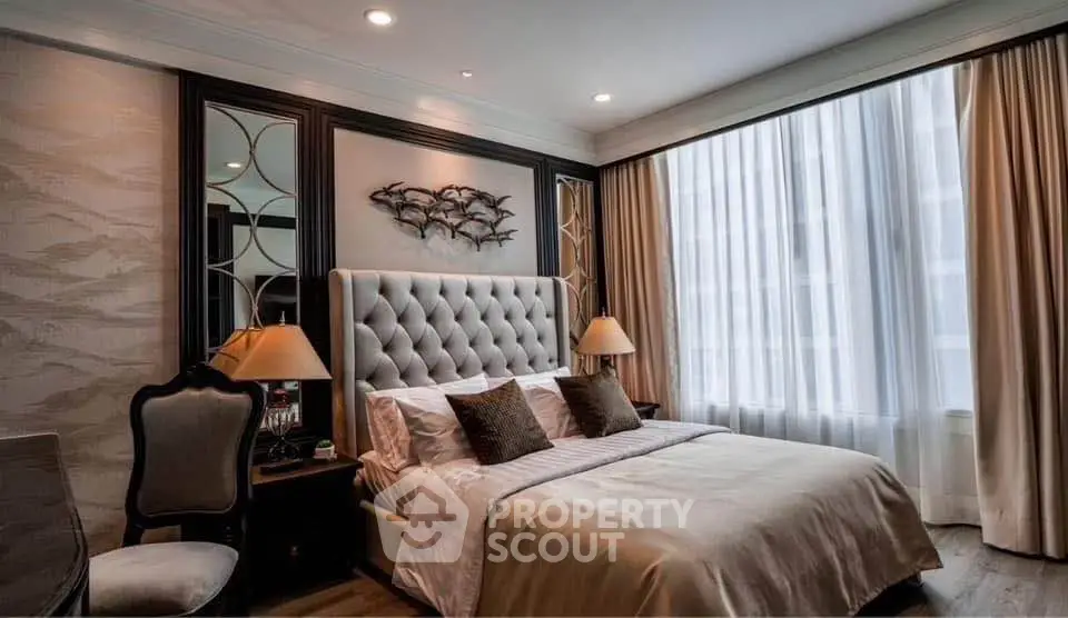 Luxurious bedroom with elegant decor and large window in upscale property.