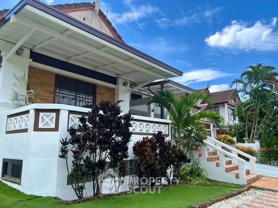 Charming suburban home with lush garden and inviting front porch, perfect for family living.