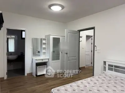 Spacious bedroom with ensuite bathroom and modern furnishings