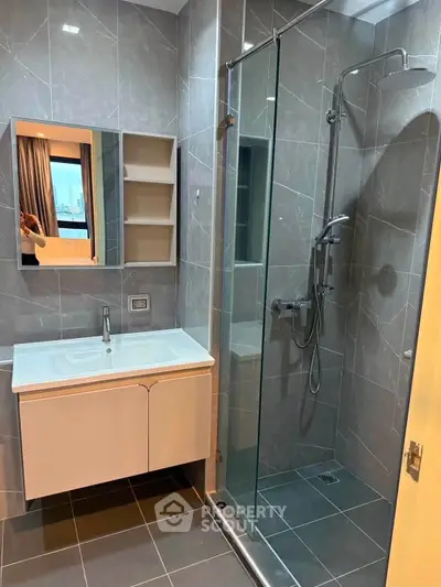 Modern bathroom with sleek shower and vanity in contemporary apartment