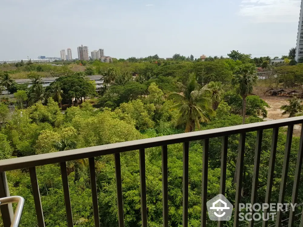 Stunning balcony view overlooking lush greenery and city skyline