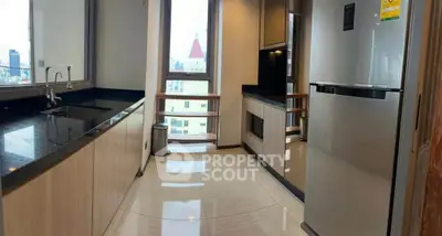 Modern kitchen with sleek design and stainless steel appliances in high-rise apartment.