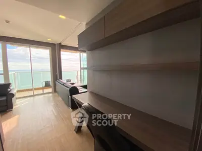 Stunning ocean view from modern living room with sleek furniture and expansive windows.