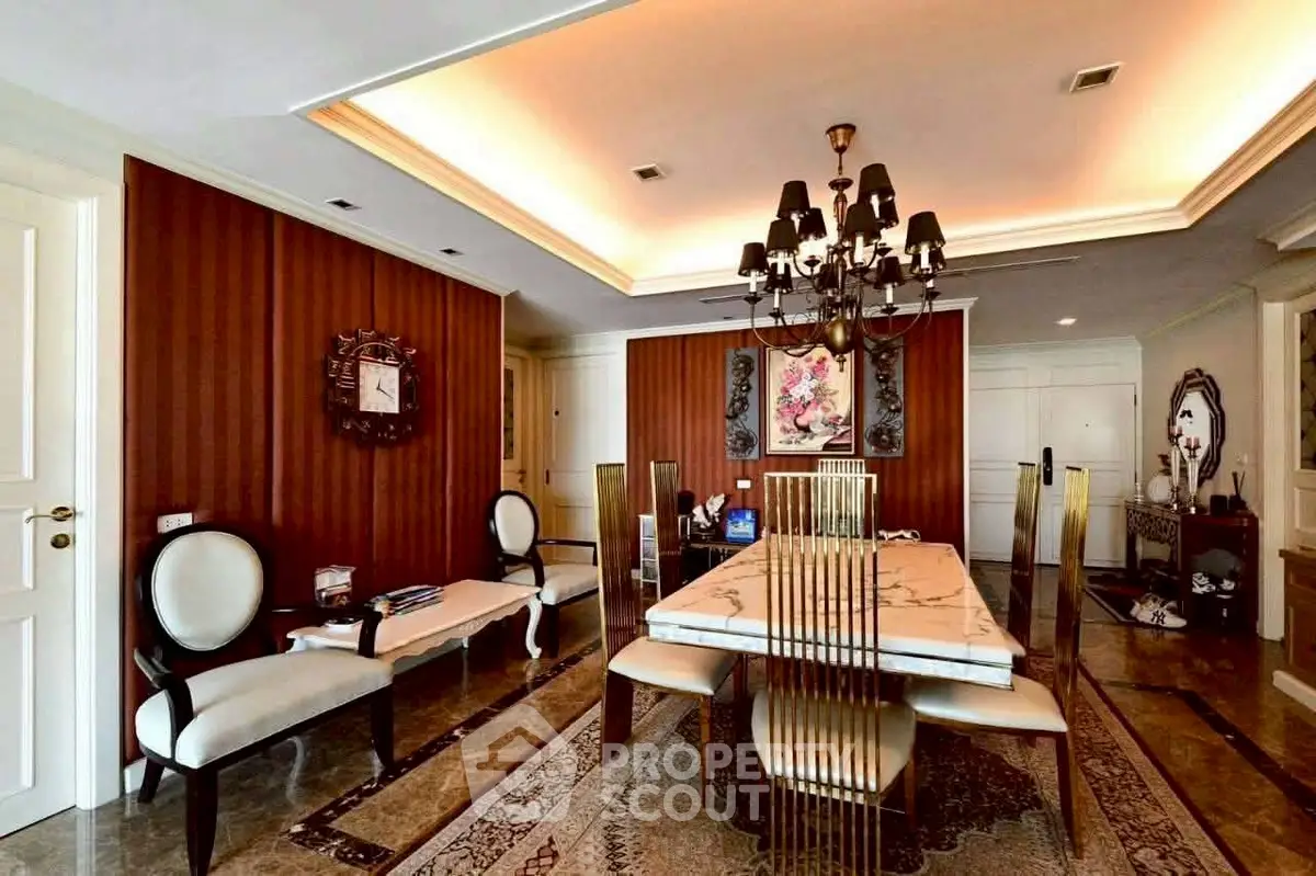 Luxurious dining room with elegant chandelier and stylish decor, perfect for sophisticated gatherings.
