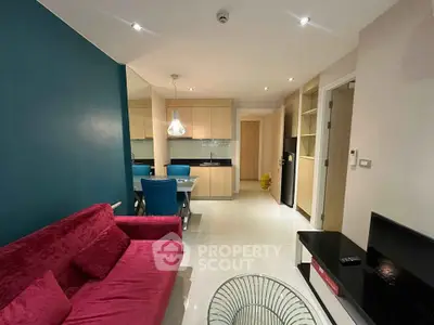 Modern living room with vibrant red sofa and stylish dining area