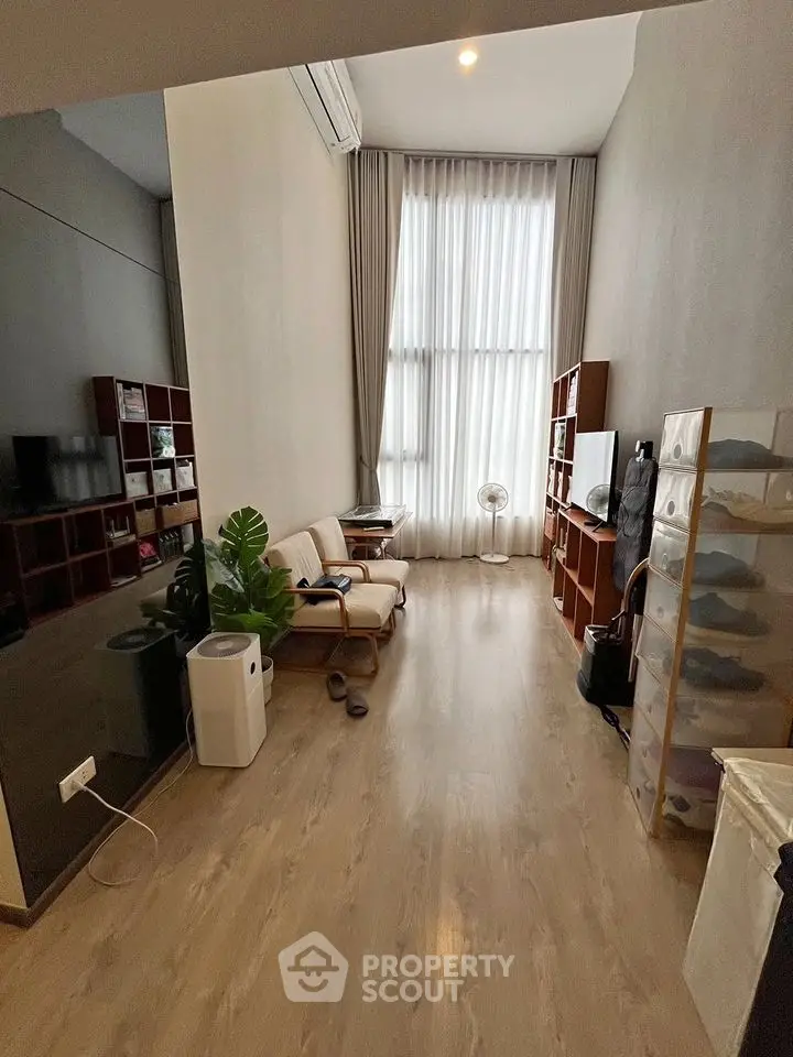 Modern living room with high ceilings and natural light