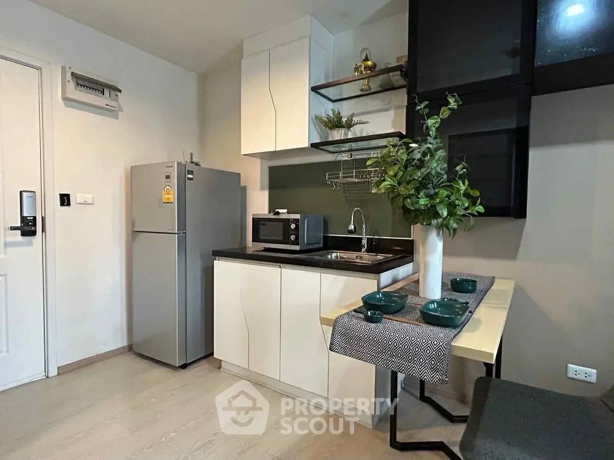 Modern compact kitchen with sleek appliances and stylish decor