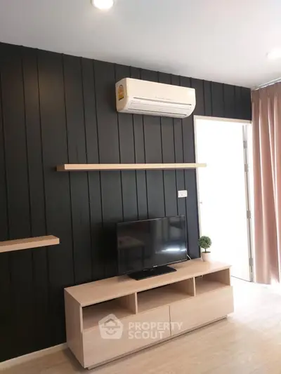 Modern living room with sleek black accent wall and air conditioning unit.