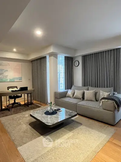 Modern living room with stylish decor and cozy seating area, perfect for relaxation and work-from-home setup.