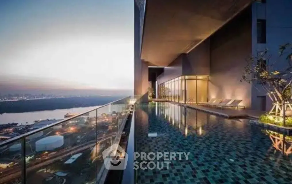Luxurious rooftop pool with stunning city skyline view at sunset.