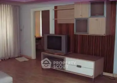 Cozy living room with modern TV stand and wall-mounted storage units.