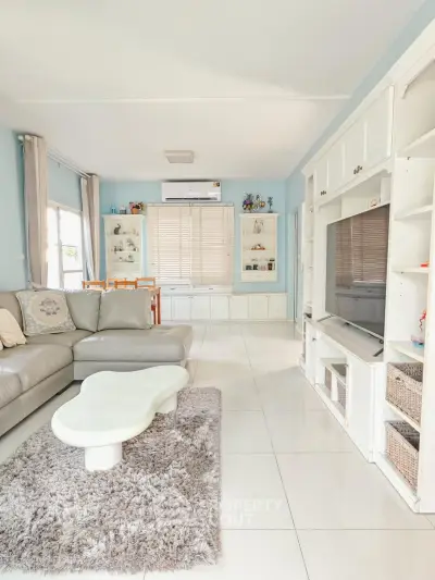 Spacious living room with modern decor and large windows for natural light.