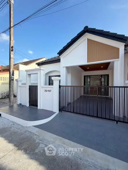 Charming modern house with gated entrance and stylish facade in a serene neighborhood.