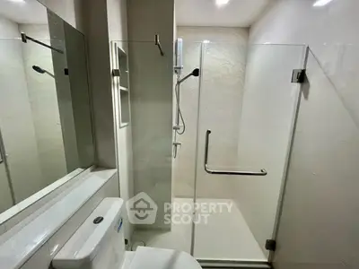 Modern bathroom with glass shower enclosure and sleek fixtures