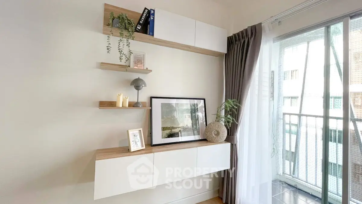Modern living room with stylish shelving and balcony view