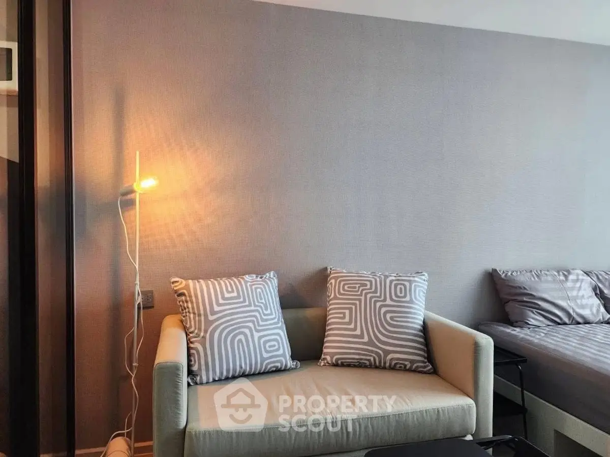 Modern living room with cozy sofa and stylish decor in a contemporary apartment.