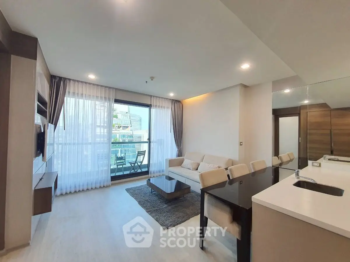 Modern open-plan living room with elegant decor and balcony view