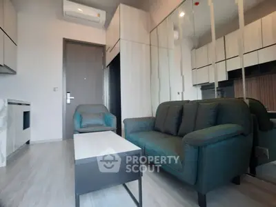 Modern living room with stylish furniture and mirrored cabinets in a cozy apartment.