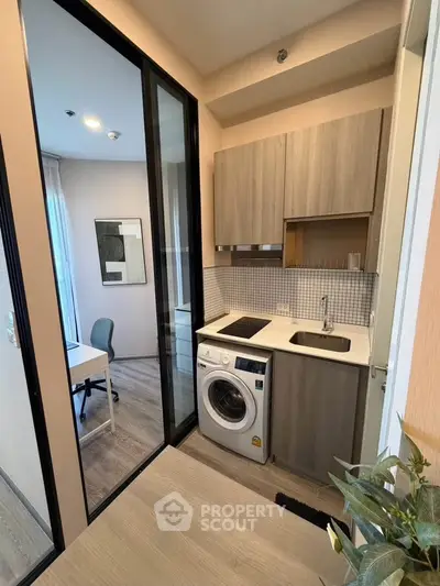Modern compact kitchen with washing machine and open layout design