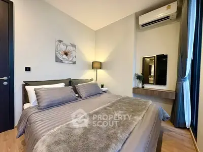Modern bedroom with cozy decor and air conditioning in a stylish apartment.