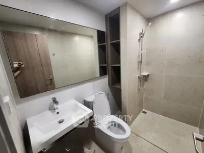 Modern bathroom with sleek fixtures and spacious shower area