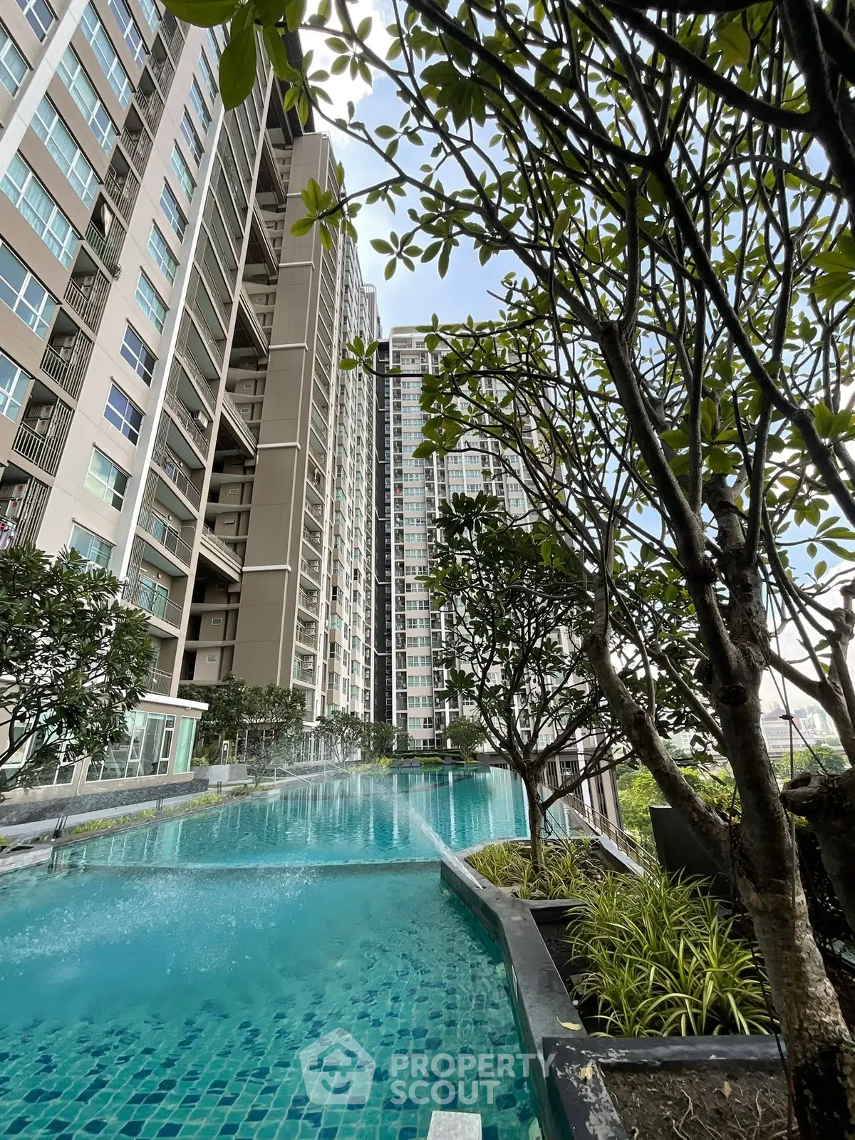 Luxurious high-rise apartment with stunning pool and lush greenery