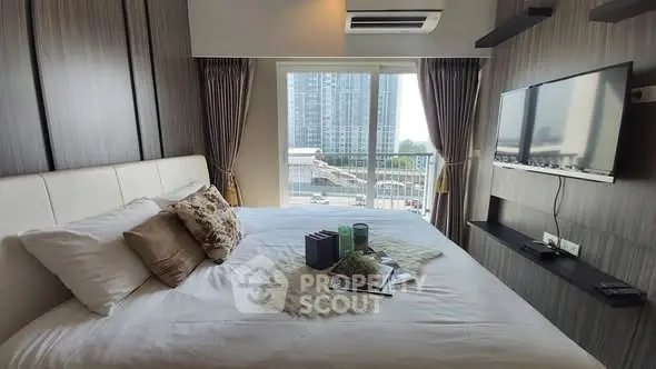 Modern bedroom with city view, stylish decor, and wall-mounted TV.