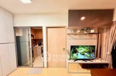 Modern living room with sleek kitchen access and stylish decor