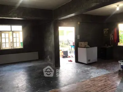 Spacious unfinished interior with concrete floors and open layout, ideal for customization.