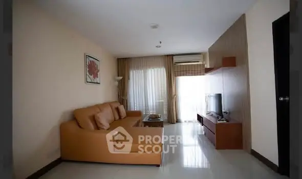 Spacious living room with modern leather sofa and flat-screen TV