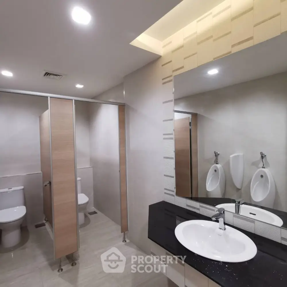 Modern bathroom with sleek fixtures and ample lighting