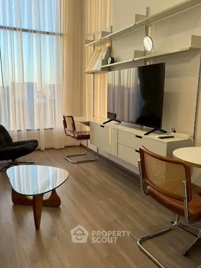 Modern living room with floor-to-ceiling windows and stylish furniture