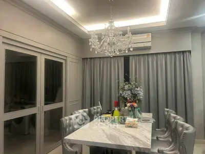 Elegant dining room with chandelier and marble table, perfect for luxury living.