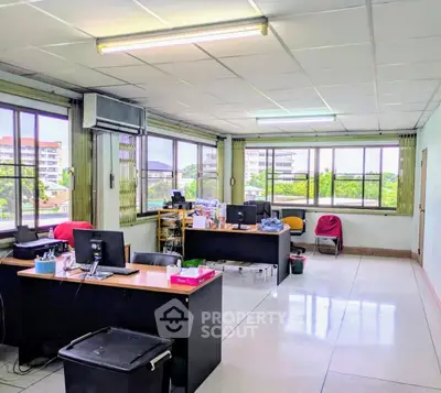 Spacious office space with large windows and natural light