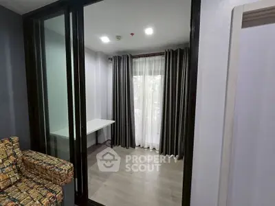 Modern apartment with sliding glass doors and stylish curtains, perfect for a cozy living space.