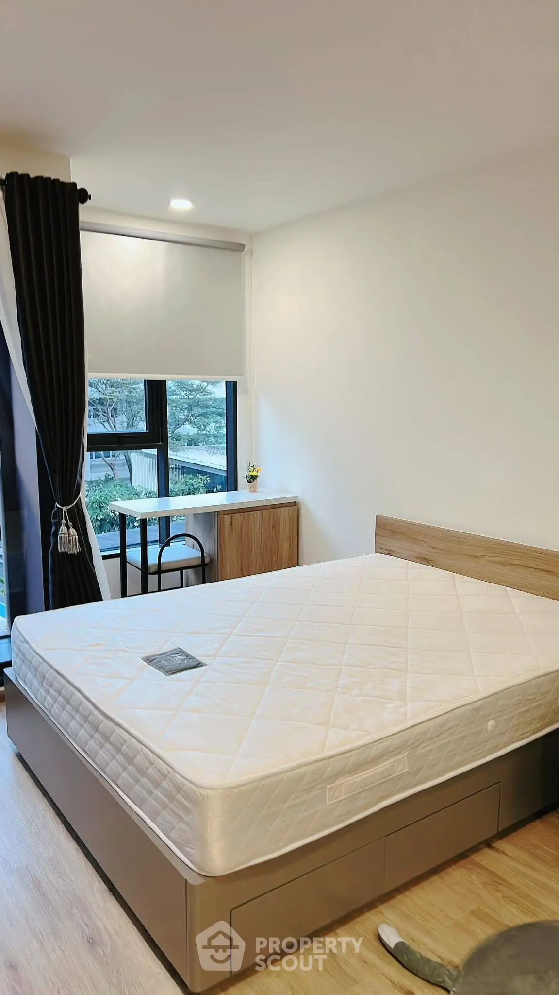 Modern bedroom with large window and minimalist decor