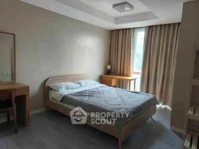 Spacious bedroom with modern furnishings and natural light