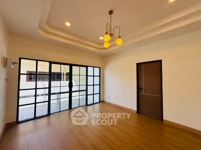 Spacious modern living room with elegant lighting and large windows