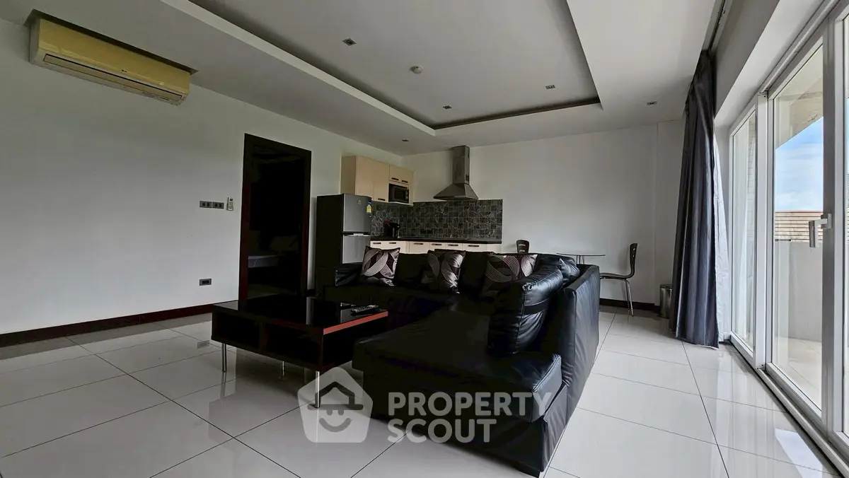 Spacious modern living room with open kitchen and large windows