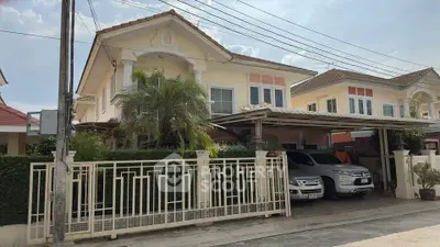 Charming suburban house with spacious driveway and lush greenery, perfect for family living.