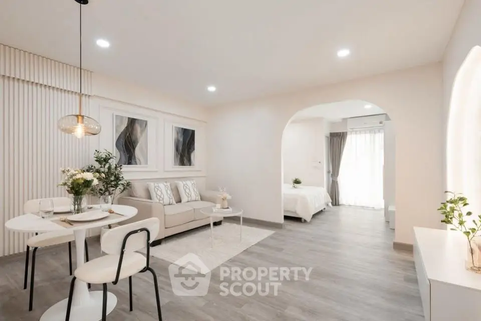 Modern open-plan living room with elegant decor and natural light