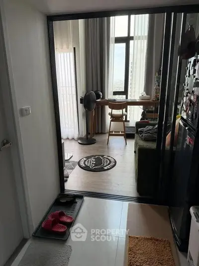 Modern apartment interior with open layout and city view, featuring a cozy living area and stylish decor.