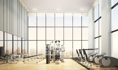 Luxurious high-rise gym with panoramic city views and modern fitness equipment.